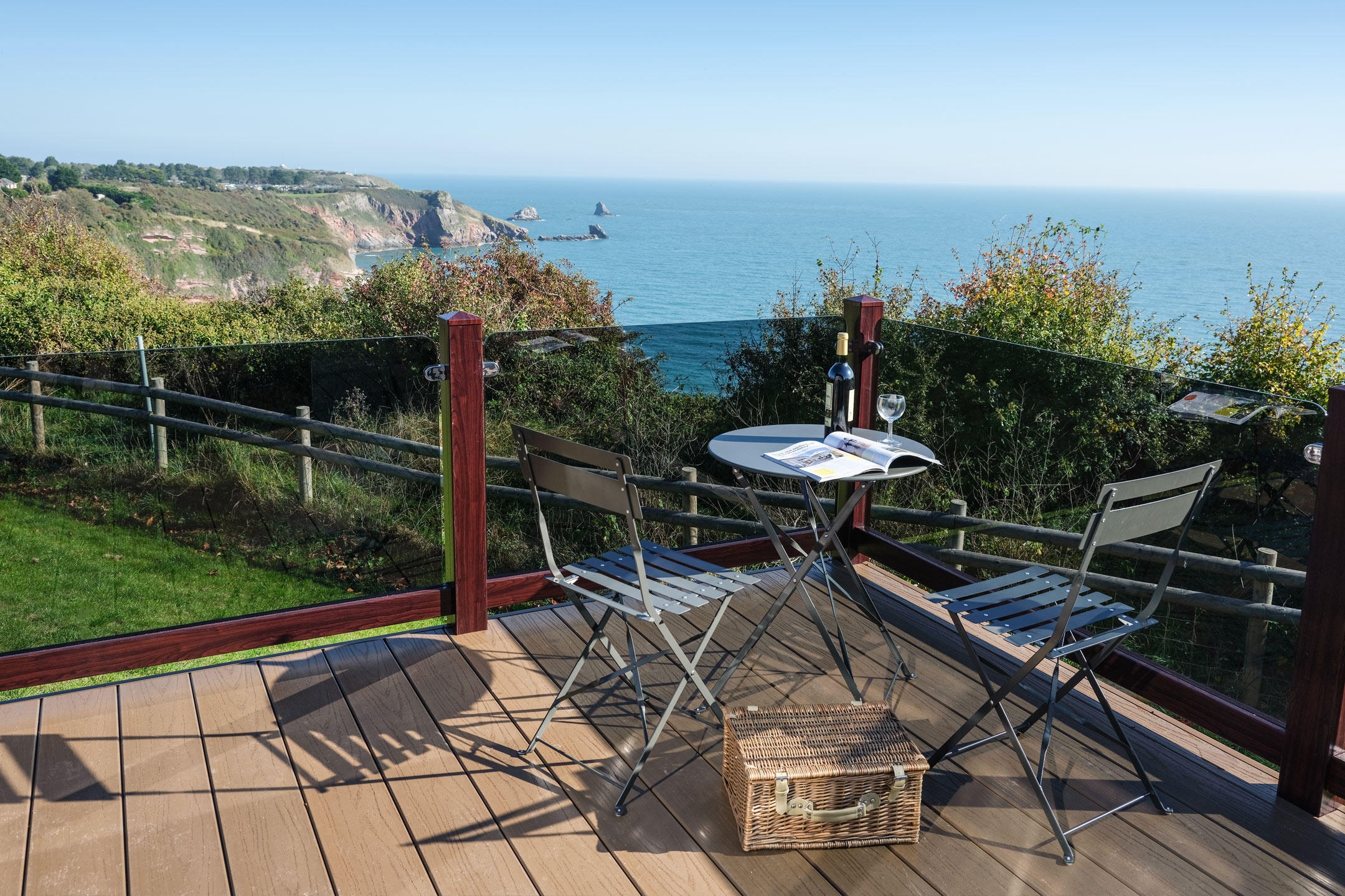 Chiltern decking board in Mink, with Rosewood posts and grey tint glass without top rail.